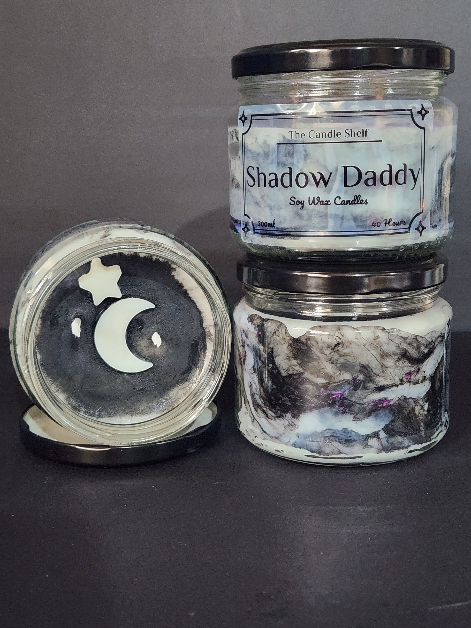 The Candle Shelf. Handmade Custom Bookish Soy Wax Candles inspired by those unforgettable moments between the pages. Beautifully marbled glass container jar candles. Shadow Daddy, Star Dust, The Last Page. Pillar candles. Book candle. Heats candle. Forest, floral and leaves candle. Their fancy and deliciously scented. The perfect decor item for your home, office, wedding or even as a gift. We offer customised labels and candle colours. Each candle is made to order.  All candles are made from NZ sourced wax.